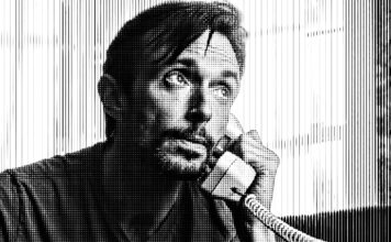 Kurzfilm: It’s OK, Johnny Stark bearbeiteter Screenshot aus dem Kurzfilm It's OK, Johnny. Mittig sehen wir einen Mann, der einen Telefonhörer ans Linke Ohr hält und in Gedanken nach oben schaut.